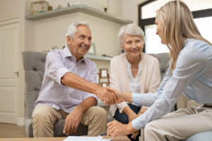 Senior couple shaking hands with financial advisor